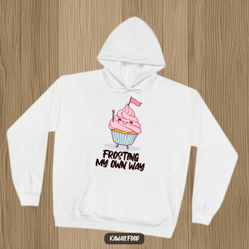 Funny hoodie showcasing a happy cupcake with legs waving a tiny flag from a delicious frosting mountain, a sweet achievement.